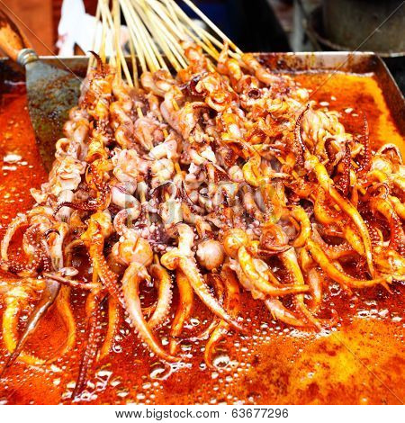 Frying of squid's tentacles skewers in Shanghai, China