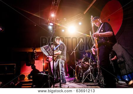 Band performs on stage, rock music concert in a nightclub