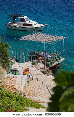 Fishermen Fixing Nets On A Pier In Croatia