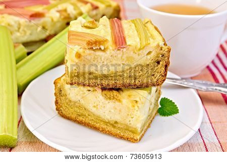 Pie with curd and rhubarb on tablecloth