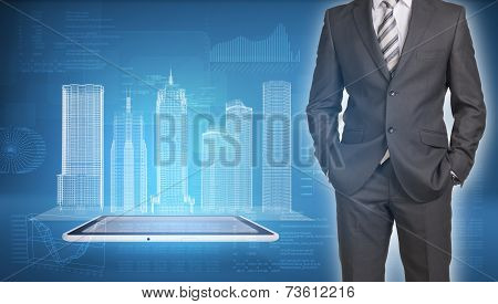 Businessman and wire-frame buildings on screen tablet pc