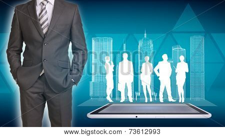 Businessman with wire-frame buildings, tablet and business silhouettes