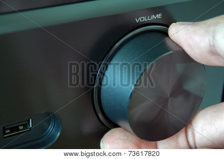 Tuning Knob And Fingers. Black Av-receiver Close-up.