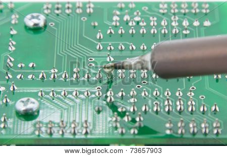 The Solder Electronics Pcb With The Soldering Iron