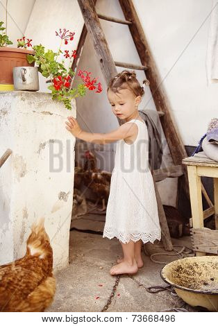Happy little girl by the old farmhouse