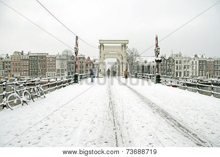 Snowy Amsterdam with the Thiny bridge in the Netherlands