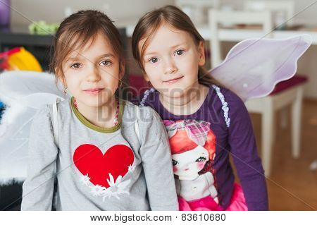 Two adorable little girls playing at home
