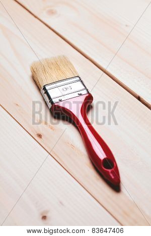paintbrush on wooden surface