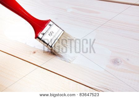 paint brush painting on wooden surface