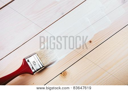 paint brush painting on wooden surface