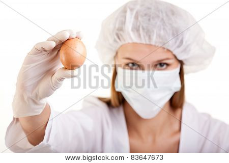 Female Scientist Showing An Egg