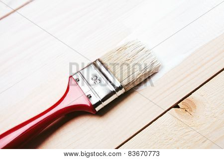 paintbrush on wooden surface