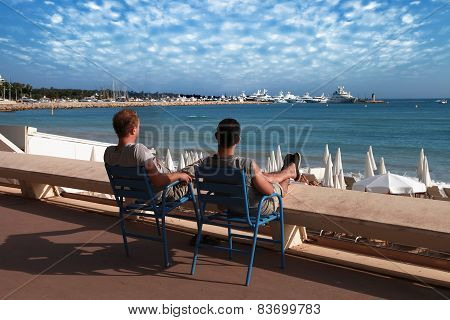Cannes, France -  July 5, 2014: Two Friends Relaxing In Chairs.