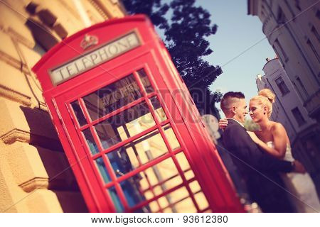 Bride And Groom Near Phonebooth