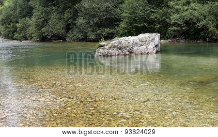 Rock In The Clear Stream With Cold Water