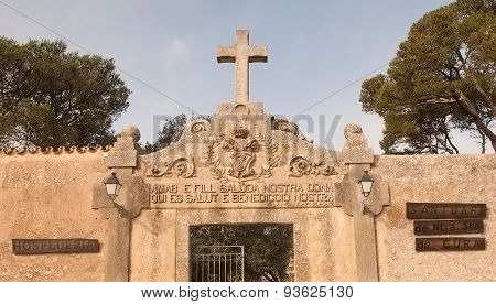 Cross and entrance inscription on the monastery Cura
