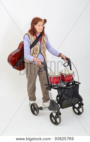 Elderly Lady With Rollator And Musical Instruments.