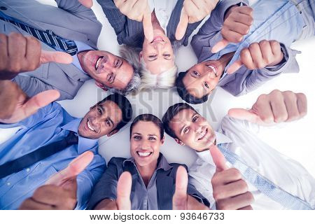 Business people gesturing thumbs up on white background
