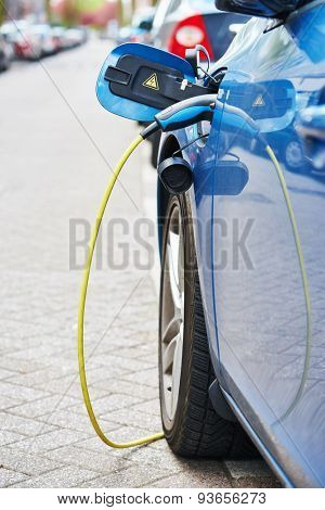 Altrernative eco energy fuel. Close up of the power supply plugged into an electric car during charging in Amsterdam