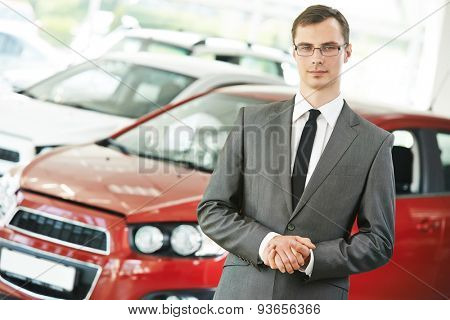 Portrait og salesperson or manager of car automobile dealer welcoming with open arms