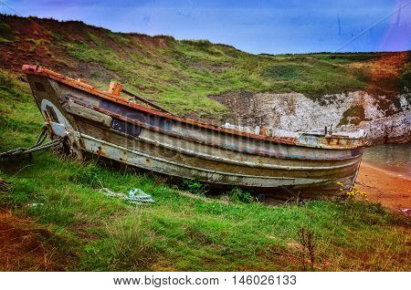 Old unused fishing boat at offshore in Flamborough bay UK used color effects