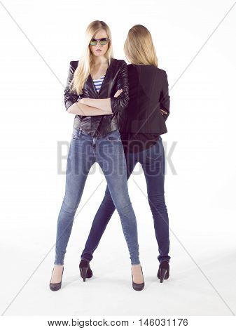 two young blonde attractive fashion model posing with trendy style in studio