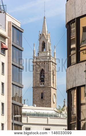 Look on bell tower of Parroquia de la Purissima Concepció across modern buildings. Barcelona Spain.