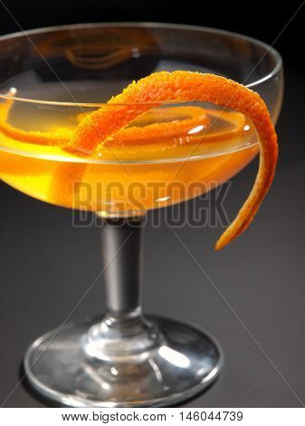 Satan Whiskers cocktail isolated on black background. Made from 1 oz gin 1/2 oz orange liqueur 1 oz dry vermouth 1 oz sweet vermouth 1 oz orange juice 2 dashes orange bitters