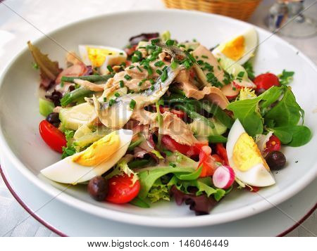 Nicoise Salad served in a restaurant in Cannes France. Horizontal tilted view