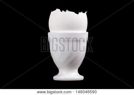 egg shells in an egg-Cup isolated over black background