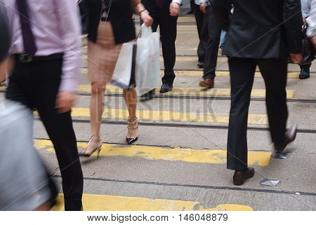 A pedestrian walking along busy street in Hong Kong
