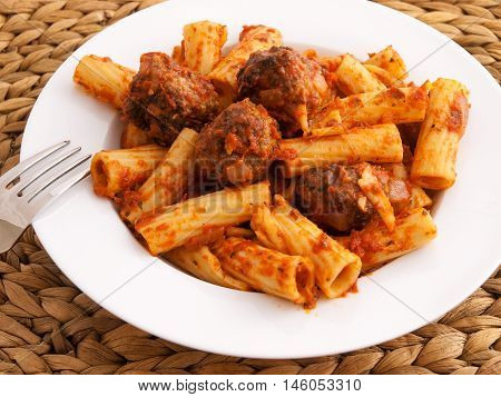 Itailian penne pasta with meatballs and tomatoes sauce. Horizontal shot