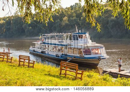 Chernihiv Ukraine - August 28 2016: Landscape with promenade motor ship Kazbek on the shore of the Desna river in the vicinity of Chernihiv Ukraine.