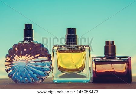 different bottle of perfume in blue background