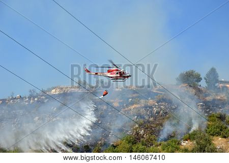 August 21 2016-Monti Prenestini-Castel San Peter- Roma-Lazio-Italy-the helicopter of the fire brigade to put out an arson attack on the slopes Prenestini who is skirting the first inhabited houses