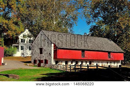 Hopewell Furnace Pennsylvania - October 15 2015: The stone and red barn for draft animals and 1770-1800 Ironmaster's Mansion  *