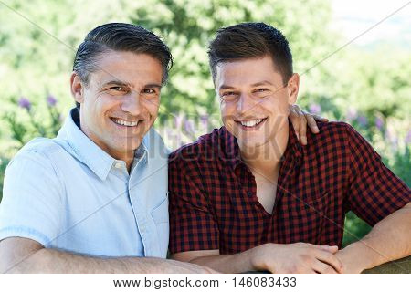 Outdoor Portrait Of Father With Adult Son