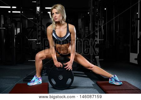Beautiful Fitness Woman Trains In The Gym.