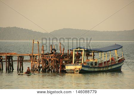 Wooden jetty and fishing boat Koh Rong Samlon island Cambodia Southeast Asia