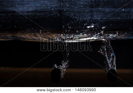 Blue Grape Dropped Into Water