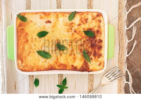 Lasagne in a baking dish. Top view, blank space