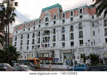Cannes, France - July 3 2012. Beautiful orange building Hotel Negresco on the Mediterranean coast.
