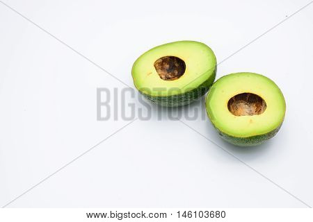 Two half avocado isolated on a white background.