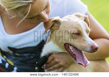 Portrait Of A Dog In Arms Of Woman