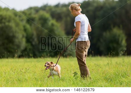 Woman With A Dog At The Leash