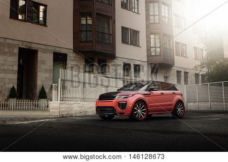 Moscow, Russia - August 06, 2016: Car Land Rover Range Rover Evoque standing on asphalt road in city Moscow at sunset