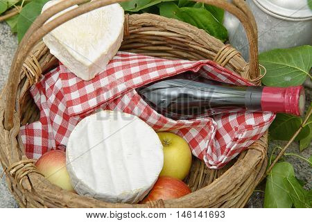 Camembert and Neufchatel cheese with bottle of wine