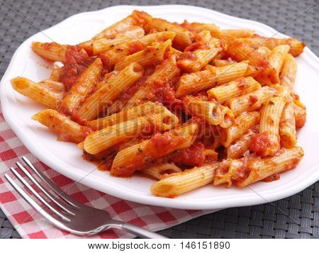 Penne pasta with tomatoes sauce. Horizontal shot
