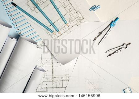 Architect working on blueprint. Architects workplace - architectural project blueprints ruler and divider compass. Construction concept. Engineering tools. Top view