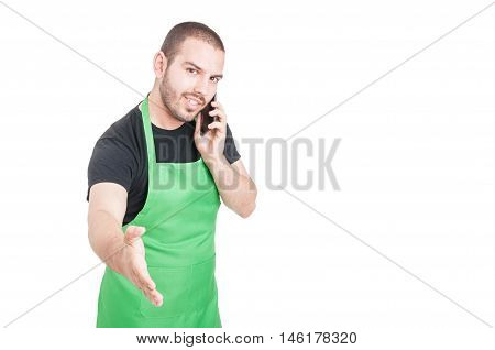 Young Supermarket Employee Making Hand Shaking Gesture At Phone